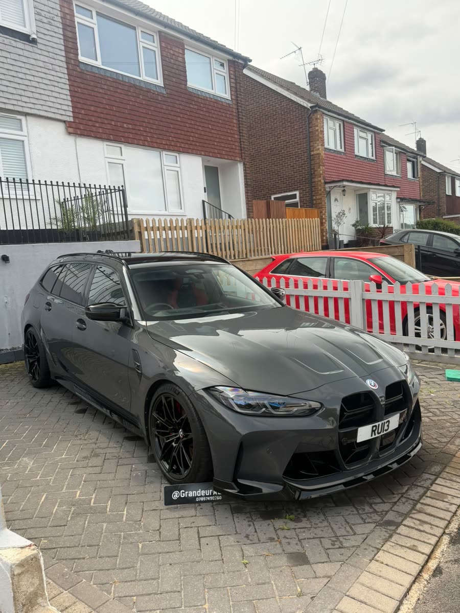 Grey BMW M3 Touring after a detail on a block-paved driveway